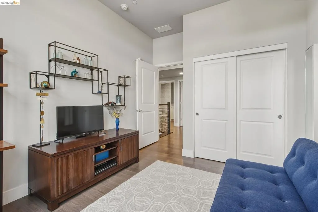 Hardwood-finish flooring, white paneled doors, and a built-in shelving unit