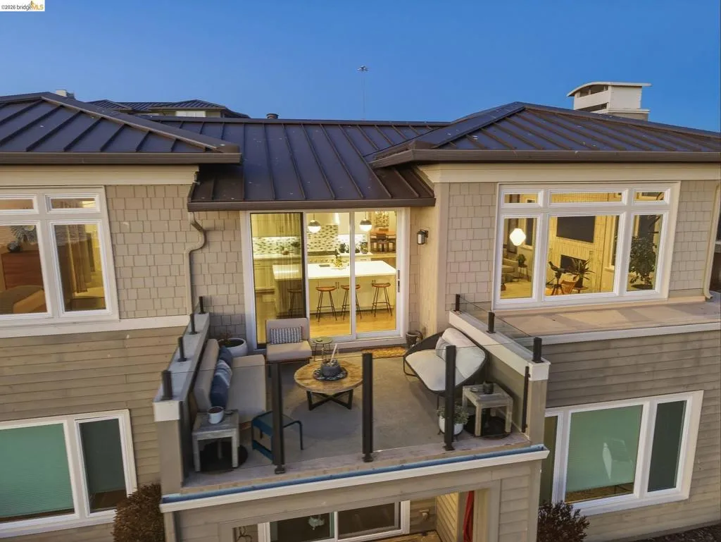 Balcony featuring glass and metal railings, providing outdoor living space