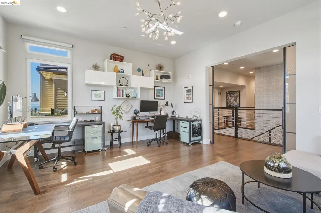 Recessed lighting, wood-finish flooring, built-in shelving, and a decorative ceiling fixture