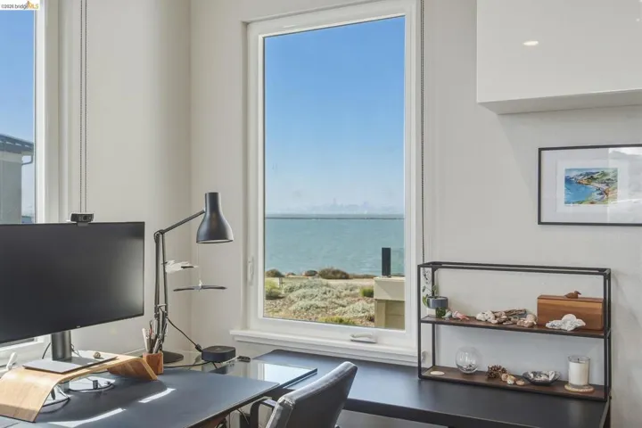 Expansive window offering water and distant city views