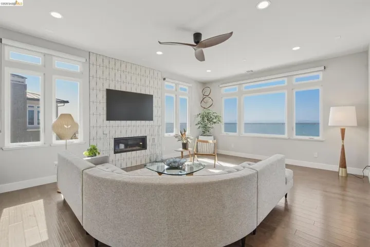 Recessed lighting, wood-finish flooring, and a ceiling fan