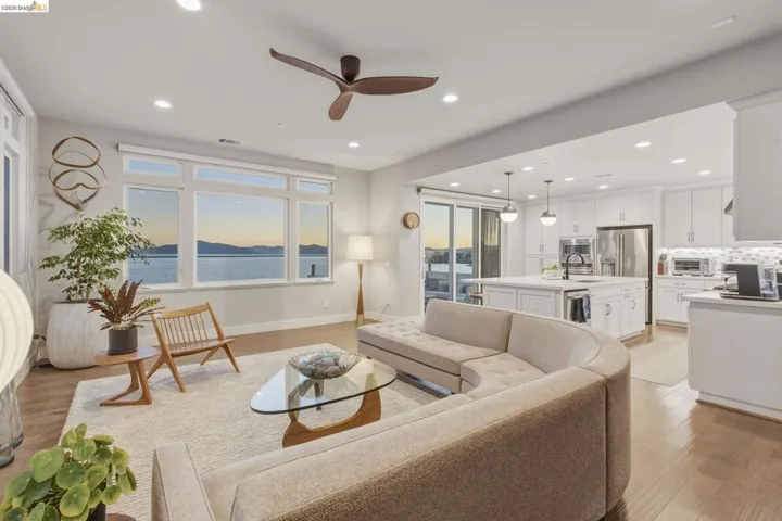 Open-concept living space featuring wood-finish flooring, recessed lighting, and a modern ceiling fan