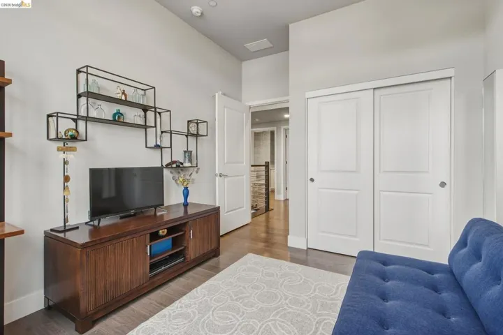 Hardwood-finish flooring, white paneled doors, and a built-in shelving unit