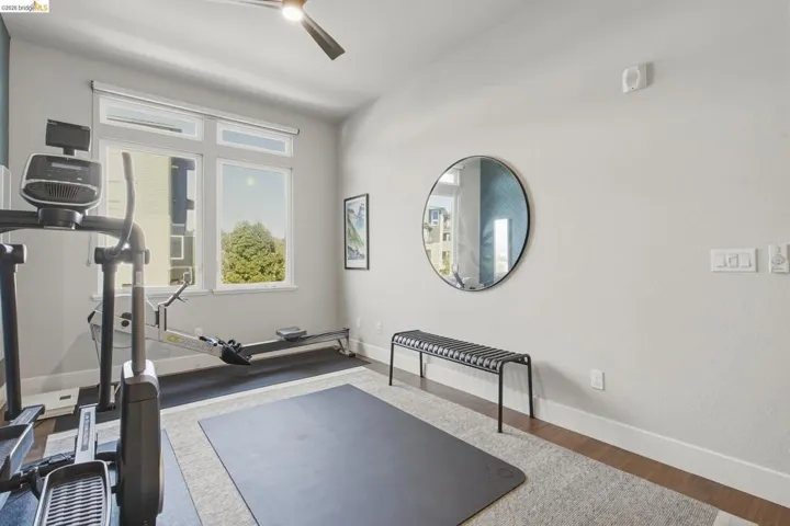Recessed lighting, wood-finish flooring, and a ceiling fan