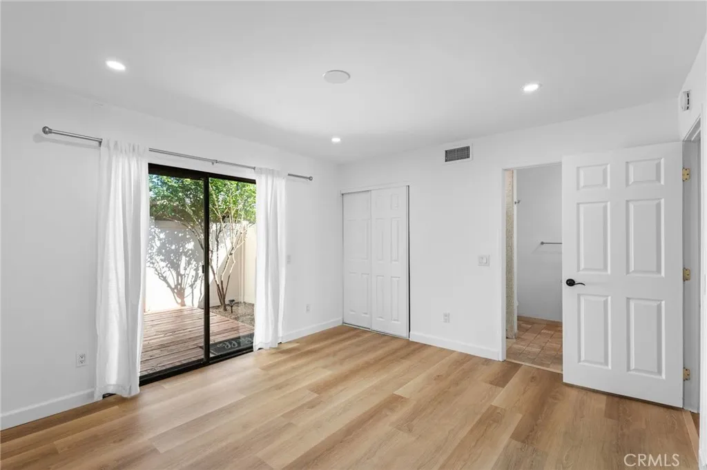 Primary Bedroom Features ensuite bathroom and private patio