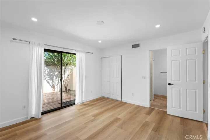 Primary Bedroom Features ensuite bathroom and private patio