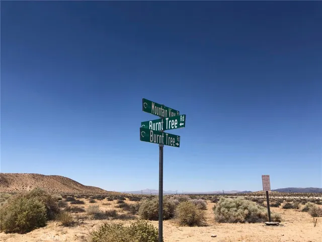 You can turn here and go west to American Way then  go north to the lot.