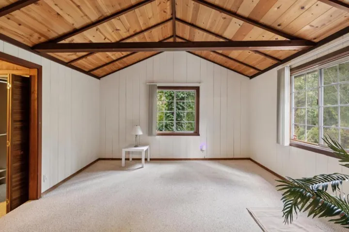 Primary bedroom suite with vaulted ceiling