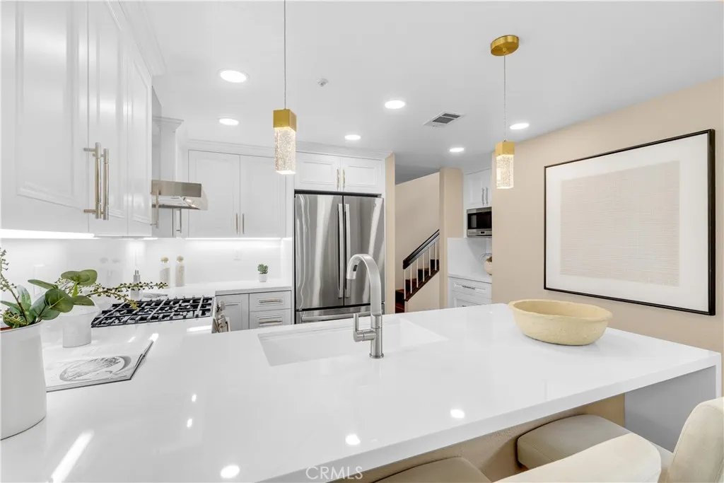 The quartz countertop feature a bartop eating area as well as a waterfall edge.