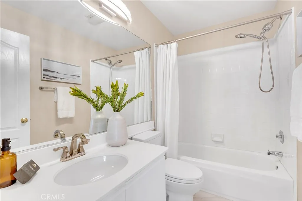 The upstairs guest bathroom has an upgraded countertop, faucet hardware and light fixture.