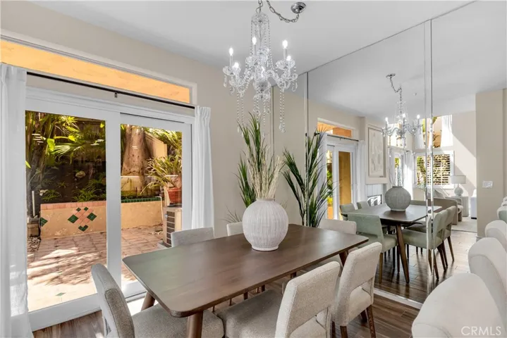 The dining room has a sliding glass door as well as a chandelier.