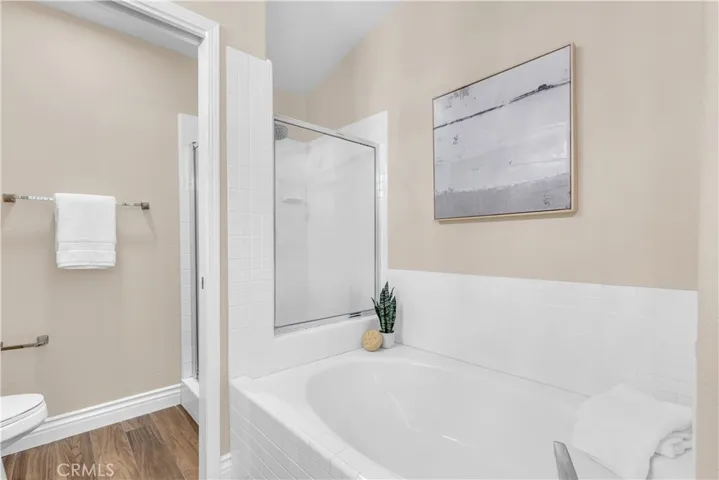 The primary bathroom has a soaking tub as well as a walk in shower.