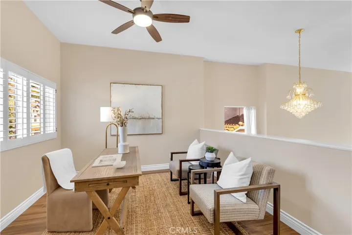 Another view of the loft area that is currently staged as an office but can easily be converted into a third bedroom if desired.