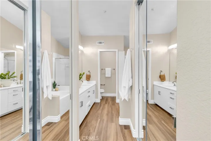 The primary bathroom has dual mirrored closets.