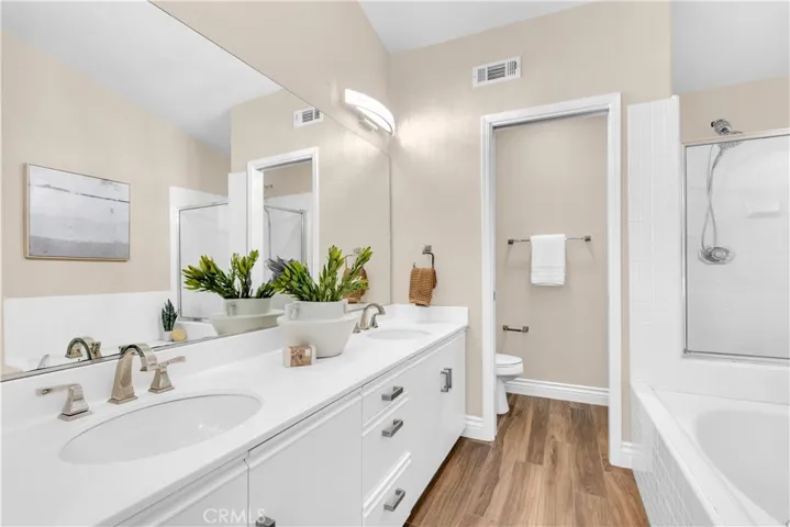 The primary bathroom has a walk in shower, a soaking tub as well as a dual vanity setup with upgrades.