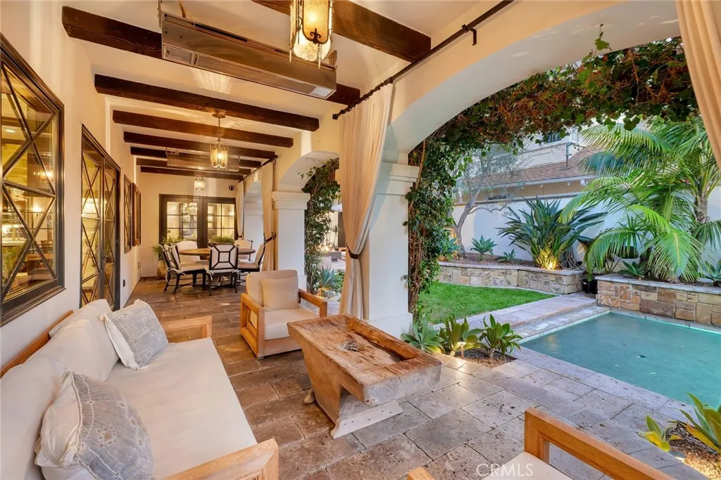 A resort-style heated arched LOGGIA ...  creates a home that lives larger, like over 4,500 sq ft,  with dining and lounging to accommodate the gala overflow.