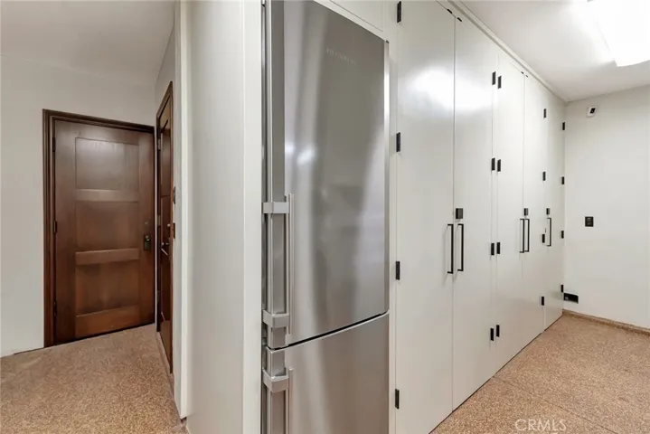 **oversized 2+ car Garage with direct access to home with tool closet adjacent, along with the Liebherr fridge, full wall of custom  cabinetry, immaculate!