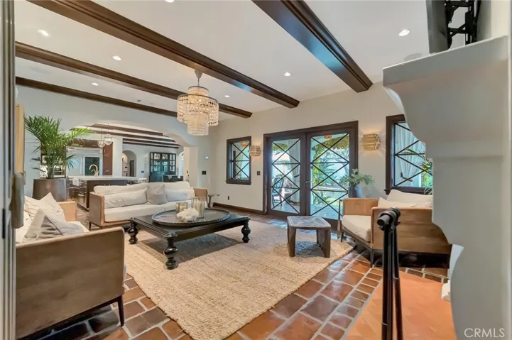 Family room is intimately adjacent to the dining area and kitchen but graciously set apart and opens directly to the loggia.