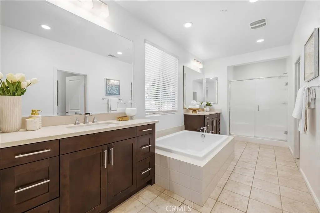 primary bathroom with dual sinks & soaking tub primary bathroom with dual sinks & soaking tub