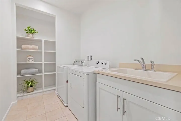 laundry room with storage (virtual staged)