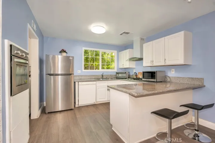 Kitchen with Granite Counters & Breakfast Bar