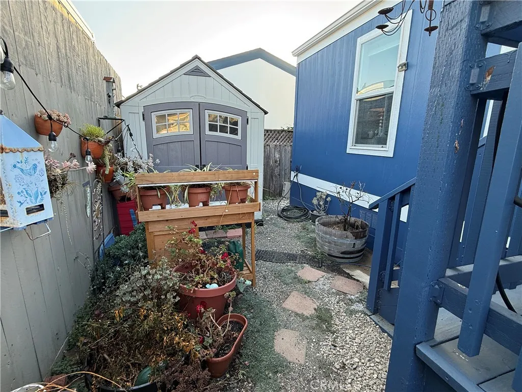 Separately fenced back garden with dog run.