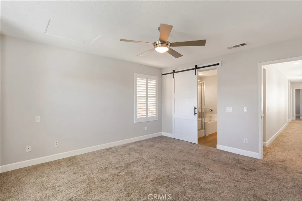 Primary Bedroom w/ Barn Door Primary Bedroom w/ Barn Door