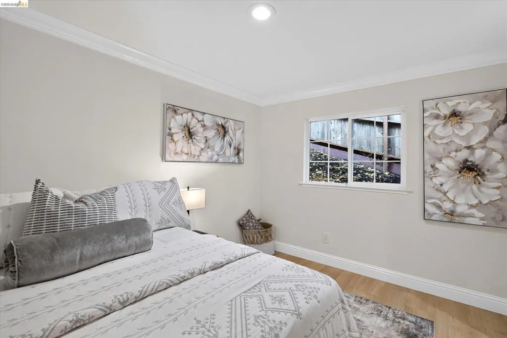 Recessed lighting, crown molding, double-pane window, wood-finish flooring, and white trim