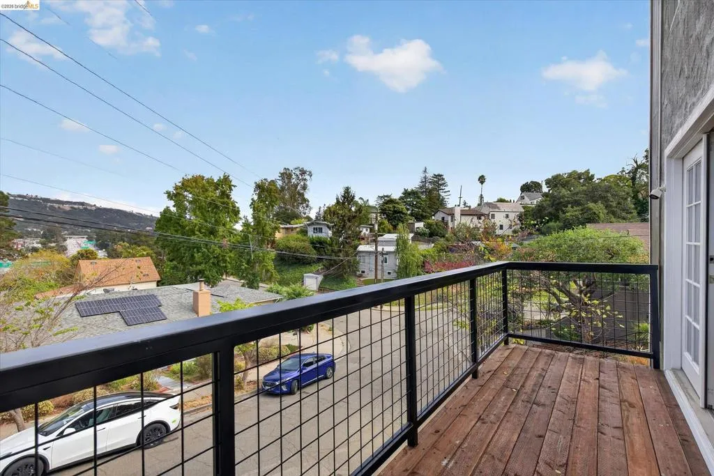 Balcony with wood-finish decking and black metal railing