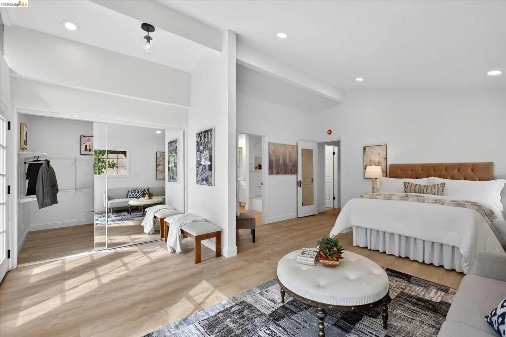 Spacious interior featuring wood-finish flooring, recessed lighting, and mirrored sliding closet doors