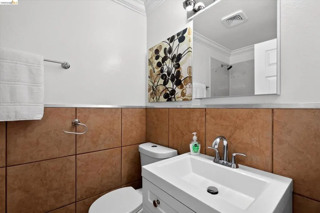 White vanity with an integrated rectangular sink and chrome faucet