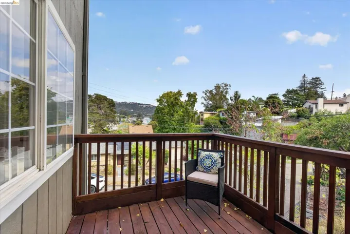 Private balcony with wood-plank flooring and wood railings