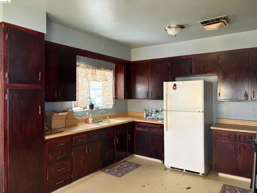 Dark wood-finish cabinetry with brass-toned hardware