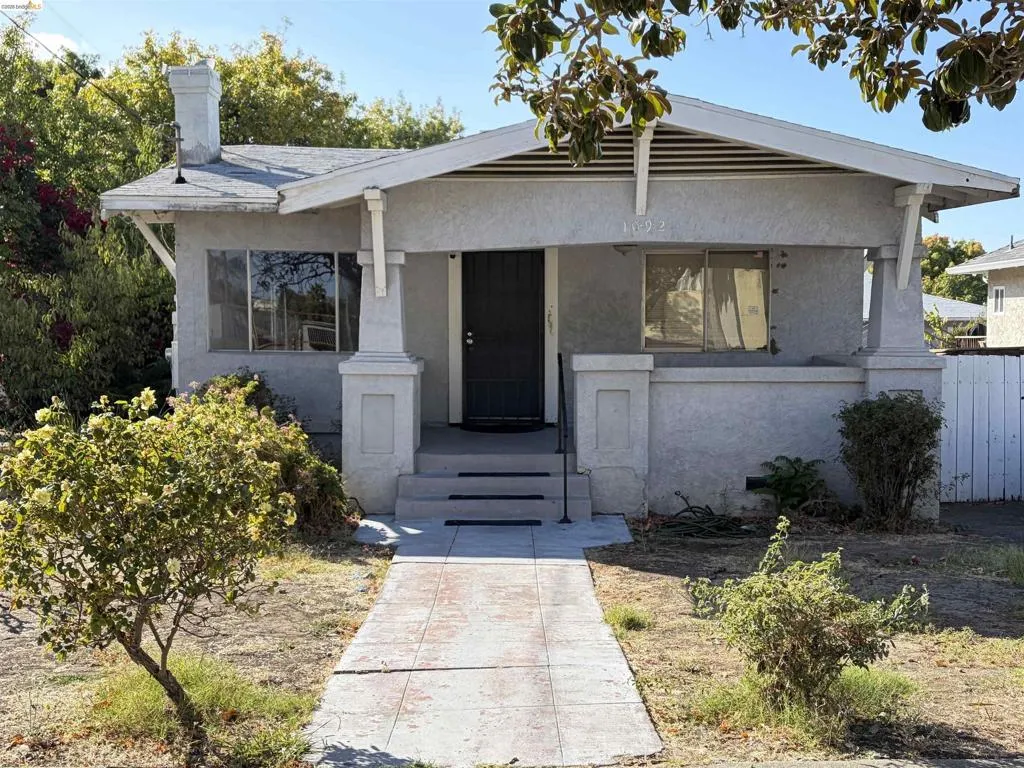 Stucco exterior with a covered porch entry
