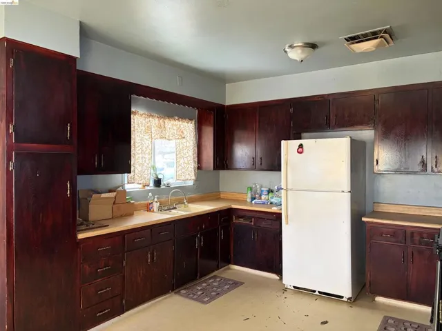 Dark wood-finish cabinetry with brass-toned hardware