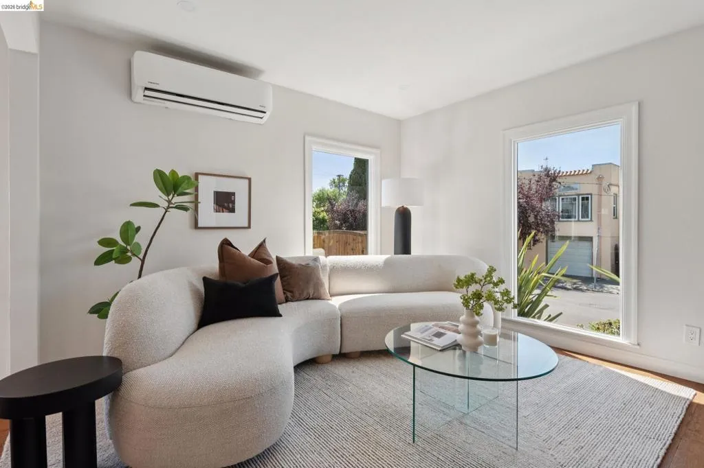 Split-system air conditioning unit, white walls, and wood-finish flooring Split-system air conditioning unit, white walls, and wood-finish flooring