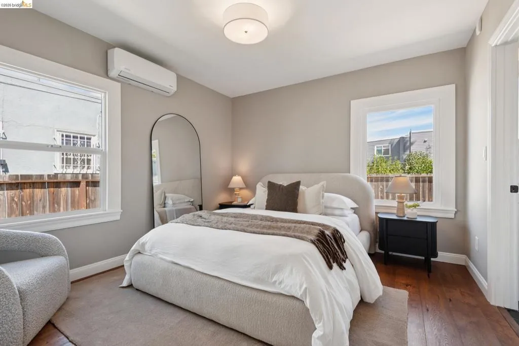 Hardwood flooring, recessed ceiling light, dual windows, and split-system air conditioning unit Hardwood flooring, recessed ceiling light, dual windows, and split-system air conditioning unit