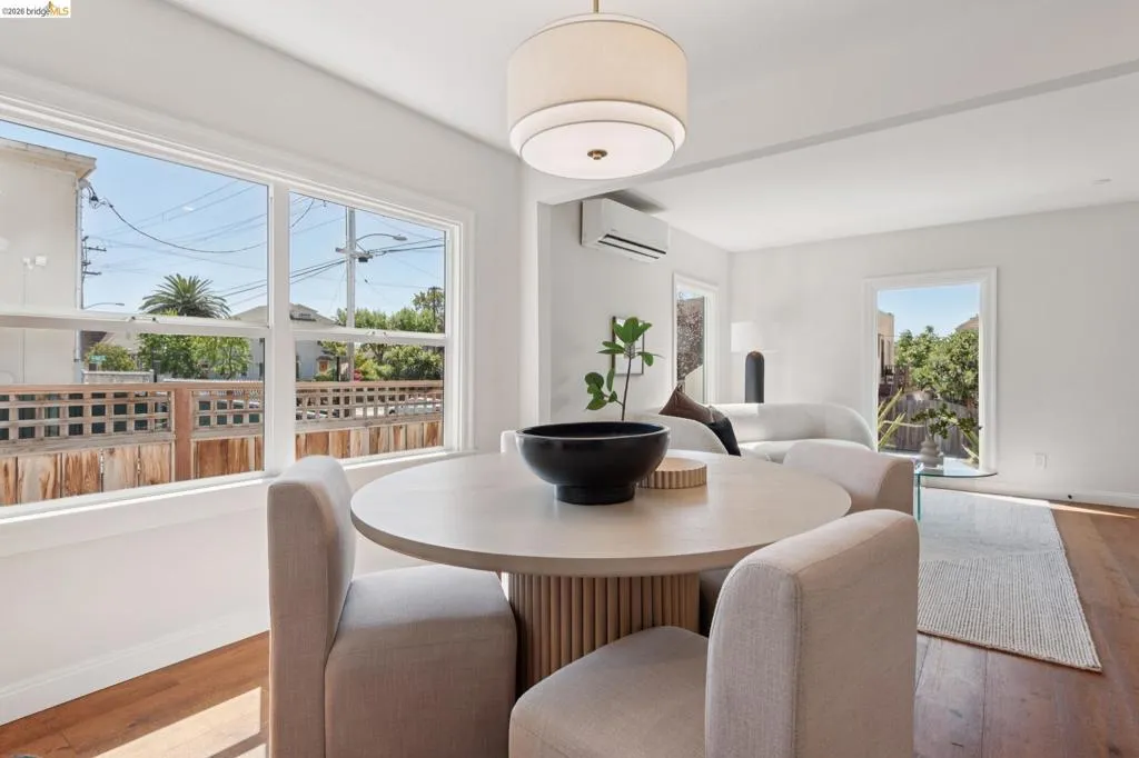 Wood-finish flooring, white walls, and a contemporary ceiling light fixture Wood-finish flooring, white walls, and a contemporary ceiling light fixture