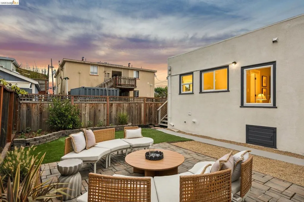 Paver patio with a gravel border, featuring a manicured lawn and perimeter landscaping Paver patio with a gravel border, featuring a manicured lawn and perimeter landscaping