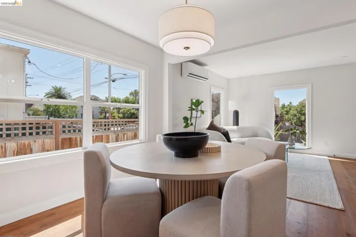 Wood-finish flooring, white walls, and a contemporary ceiling light fixture