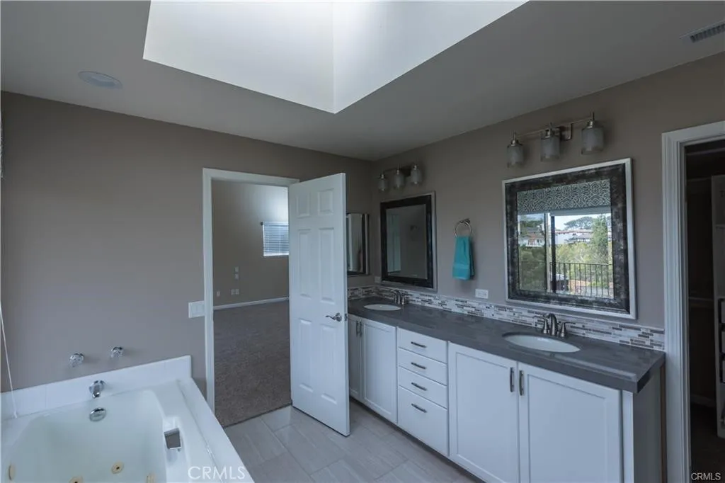 Primary bedroom , Jacuzzi tub over looking Coastal Canyon with walk in closet and walk in shower with glass enclosure.