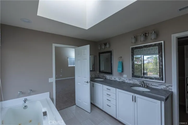 Primary bedroom , Jacuzzi tub over looking Coastal Canyon with walk in closet and walk in shower with glass enclosure.