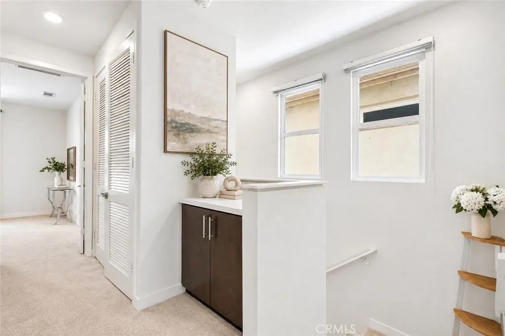 Stairs up to top floor, Hallway and laundry room + linen storage