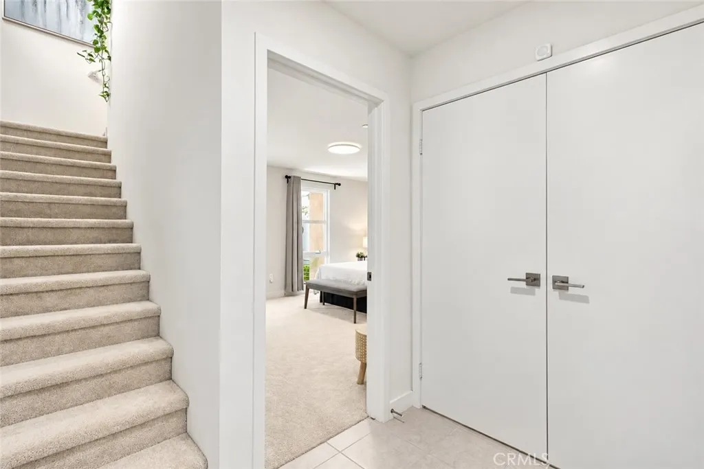 Entry way leading up to main level & guest suite with Large walk in closet