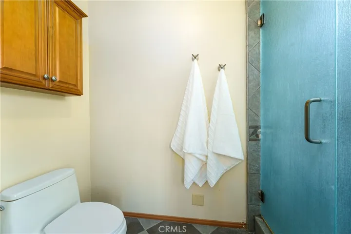 Primary bathroom also has a separate commode with a door for privacy.