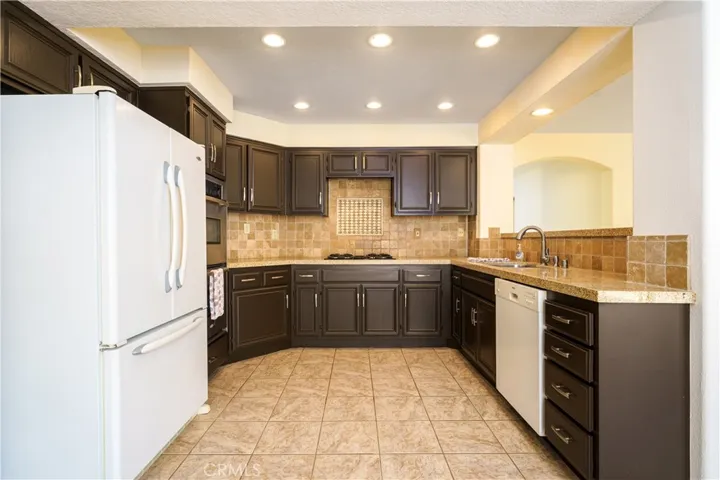 The kitchen sink looks over into the family room yet the dishes stay hidden if you are enjoying a family room movie.
