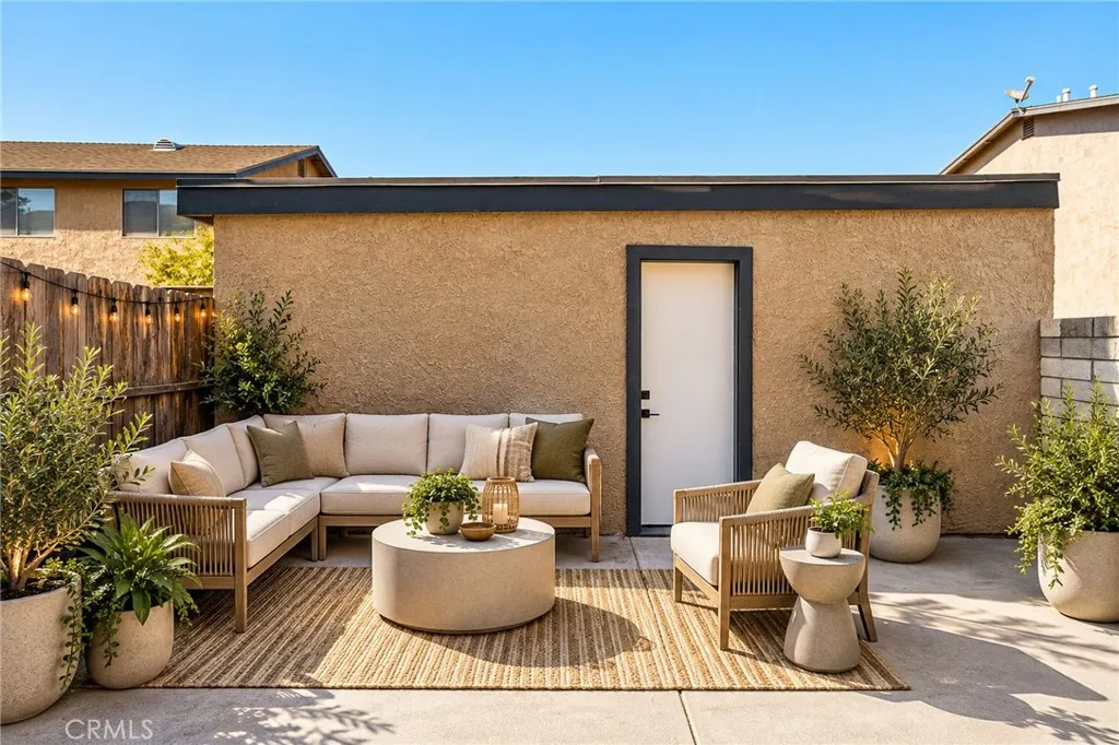 Virtually staged patio area leading to garage. Virtually staged patio area leading to garage.