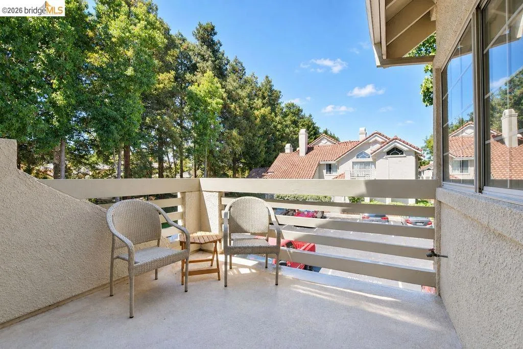 Private balcony with exterior wall texture and wood railings