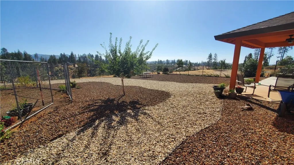 View of fenced back yard area with covered back patio. View of fenced back yard area with covered back patio.