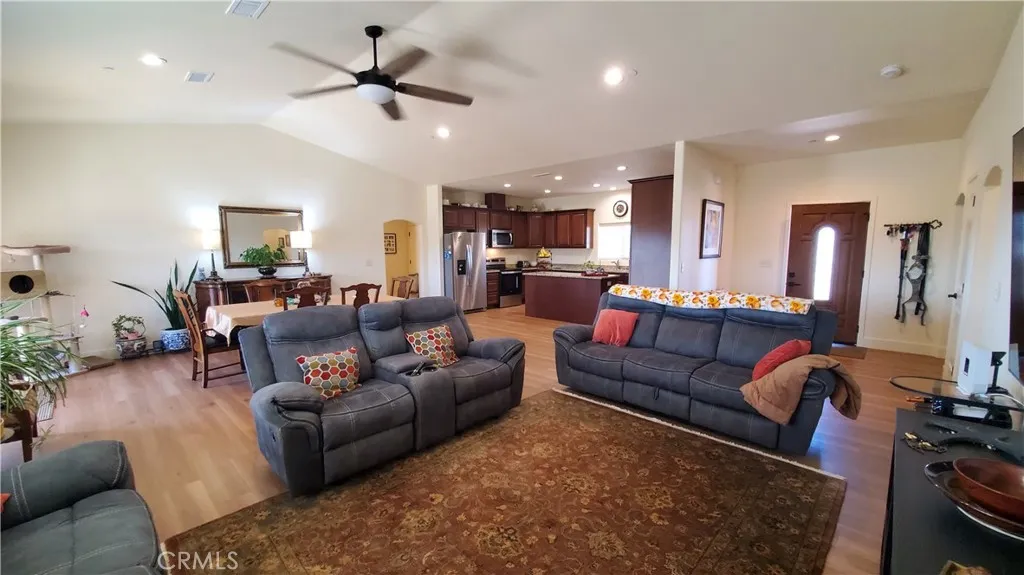 View of living room with vaulted ceilings, open to the front entry and kitchen area. View of living room with vaulted ceilings, open to the front entry and kitchen area.